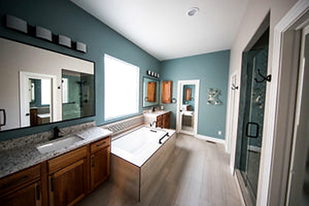 Compact modern bathroom in teal and grey with a floating vanity